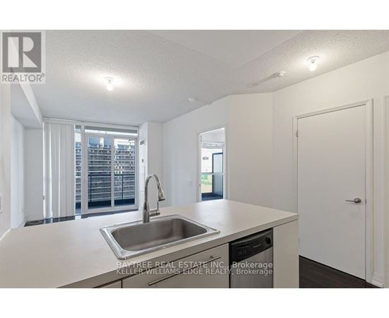 A kitchen with a sink and a window.