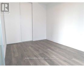 A room with wooden flooring and white walls.