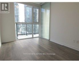 A room with a large window and sliding glass doors.