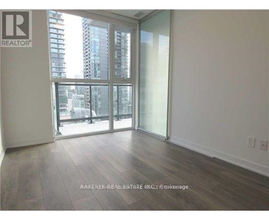 A room with a large window and sliding glass doors.