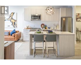 A modern kitchen with a dining table and chairs.