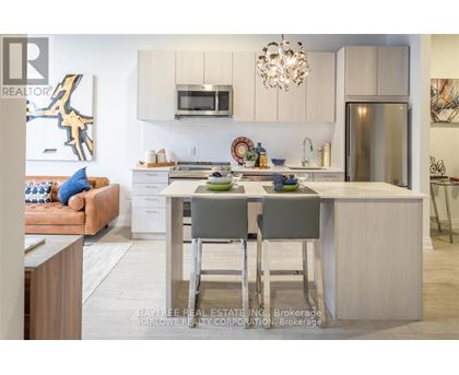 A modern kitchen with a dining table and chairs.