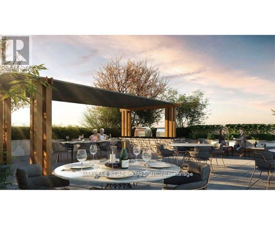 A dining area with tables set for a meal under a wooden pergola.
