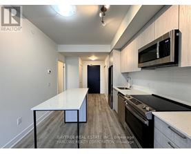A kitchen with a table and a microwave.