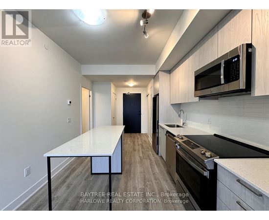 A kitchen with a table and a microwave.