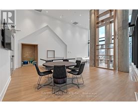A modern dining room with a large table and chairs.