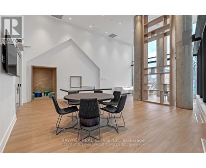 A modern dining room with a large table and chairs.