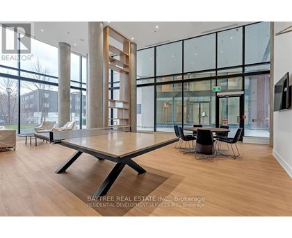 A modern living room with a large table and chairs.