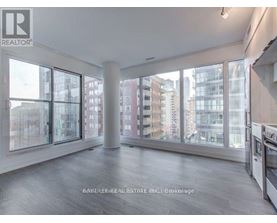 A spacious, empty room with large windows overlooking a cityscape.