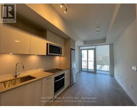 A kitchen with a sink, microwave, and oven.