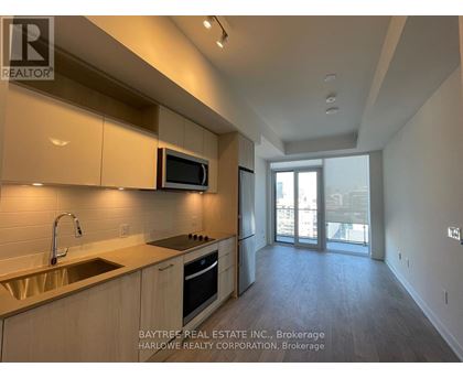 A kitchen with a sink, microwave, and oven.