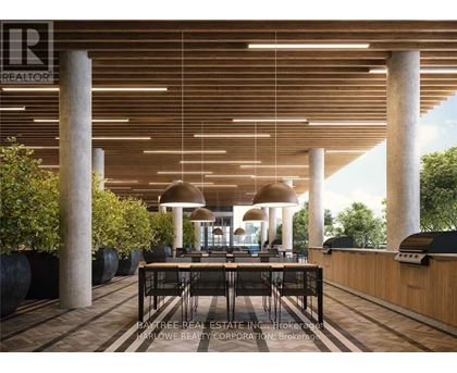 A modern dining area with a long table surrounded by chairs and a ceiling with wooden slats.