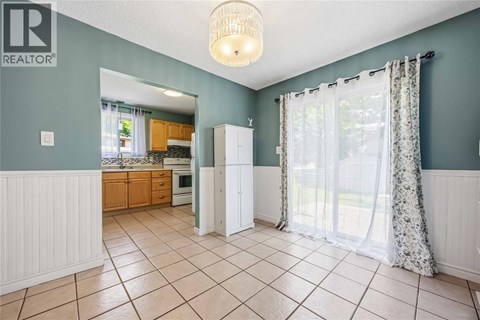 A kitchen with a white refrigerator and a white cabinet.