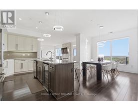 A modern kitchen with a dining table and chairs.