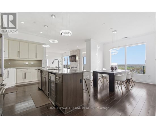 A modern kitchen with a dining table and chairs.