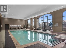 A large indoor swimming pool with a slide.