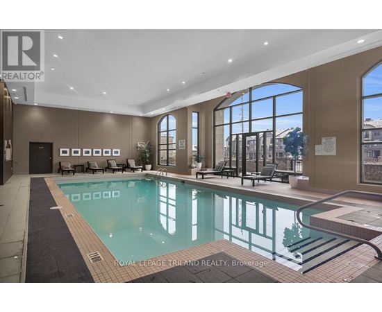 A large indoor swimming pool with a slide.