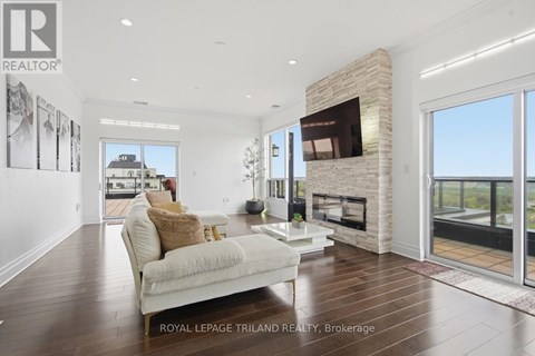 A living room with a white couch and a fireplace.