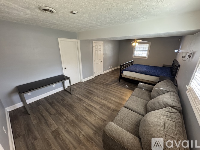 A room with a bed, a bench, and a couch.