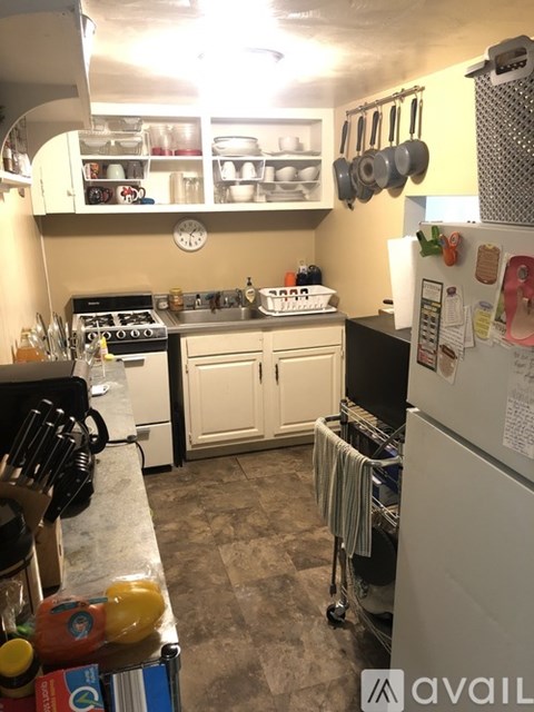 A kitchen with a white fridge and a white oven.
