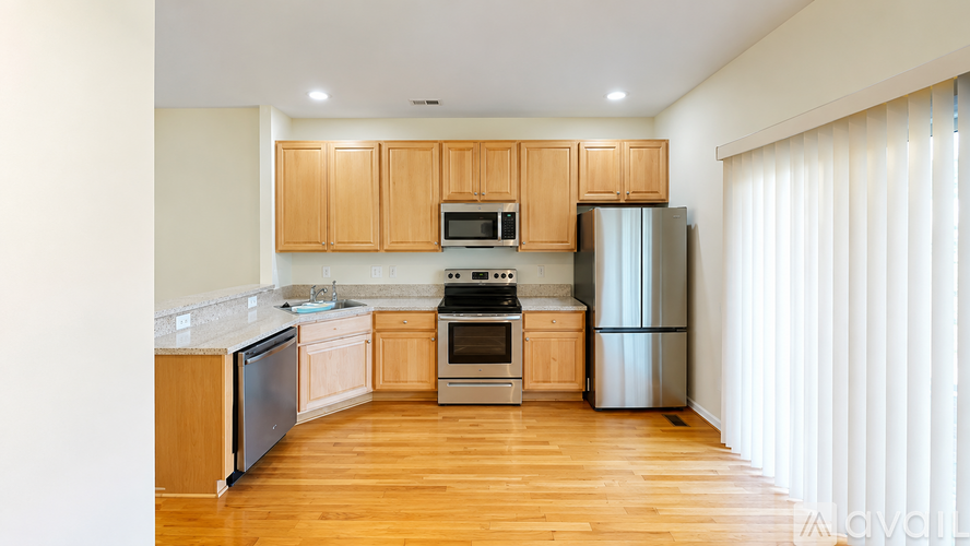 A kitchen with wooden cabinets and stainless steel appliances.