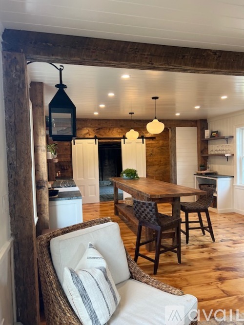 A cozy dining area with a wooden table and chairs.