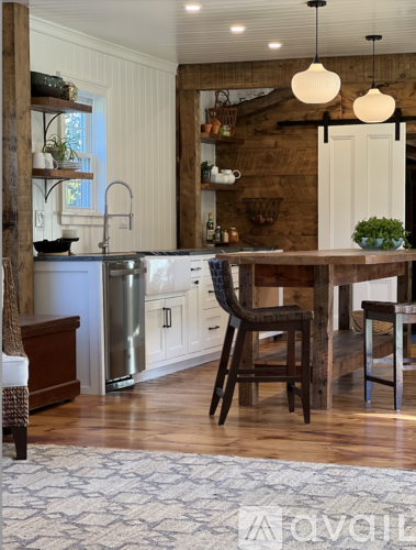 A kitchen with a wooden table and chairs.