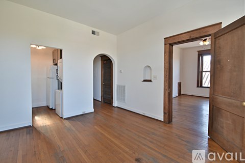 A room with wooden floors and white walls.