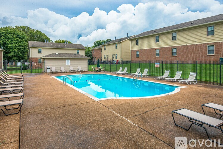 A pool surrounded by chairs and a fence with a sign that says "available".