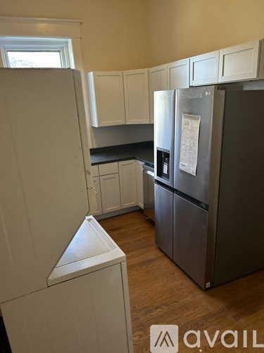 A kitchen with a white fridge and cabinets.