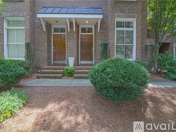 A house with a brick facade and a brown front door.