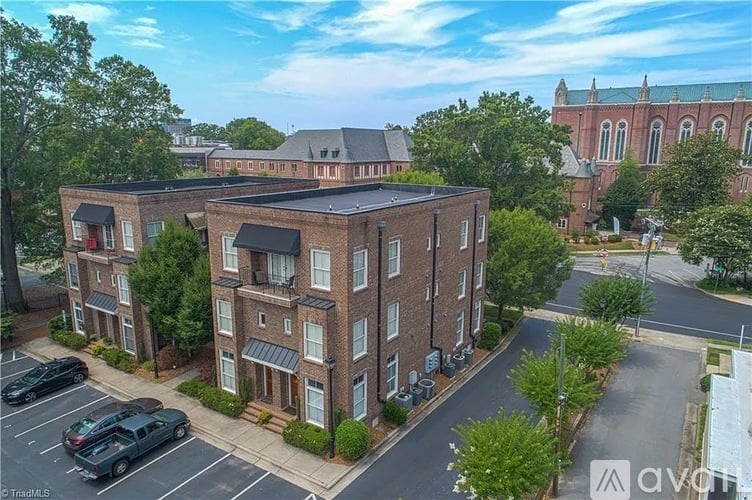 A large brick building with a parking lot in front.