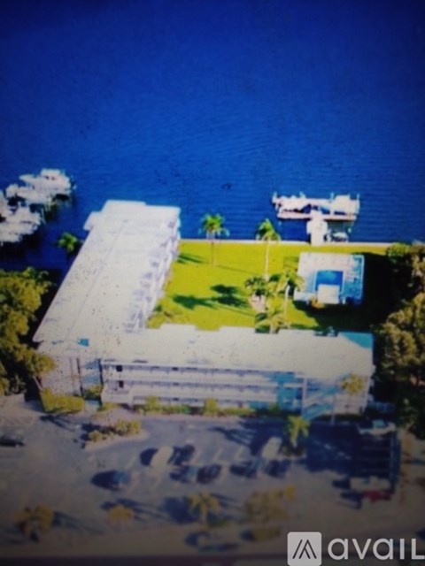 A house with a white roof is situated on a cliff overlooking the ocean.