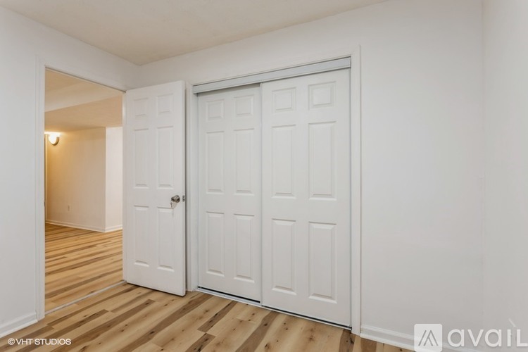 A white double door with a white frame is closed.