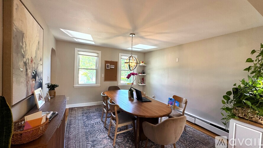 A dining room with a table and chairs.