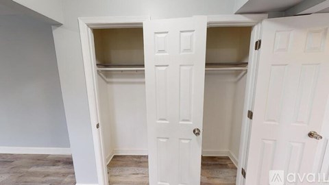 Two white doors open to reveal empty shelves.