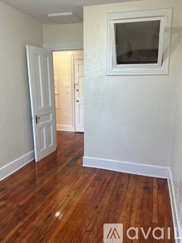 A room with wooden floors and white walls.