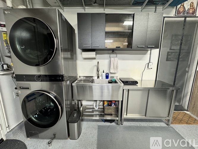 A stainless steel kitchen with a large oven and a sink.