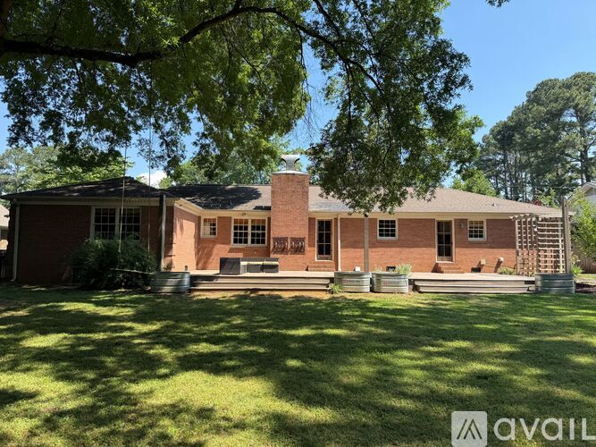 A house with a red brick exterior and a large front yard.