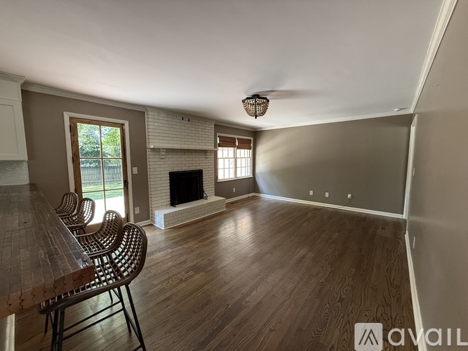 A living room with a fireplace and a dining table.