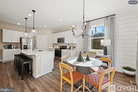 A kitchen with a table and chairs in the middle of the room.