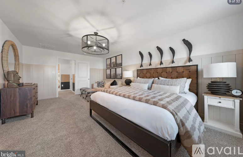 A bedroom with a large bed and a wooden headboard.