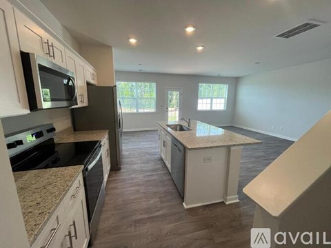 A kitchen with granite countertops and stainless steel appliances.