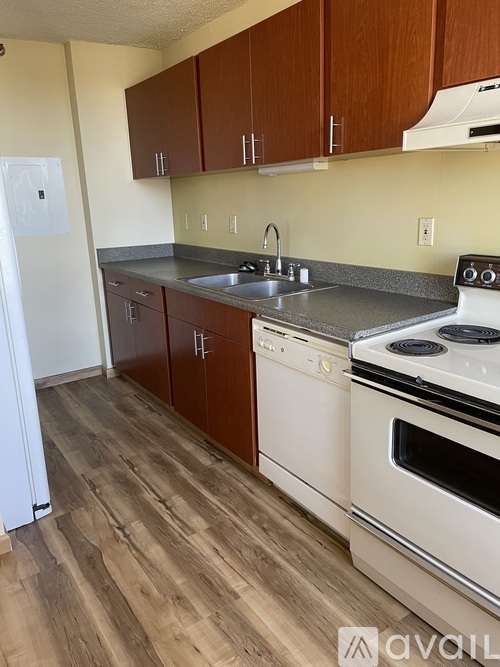 A kitchen with wooden cabinets and white appliances.
