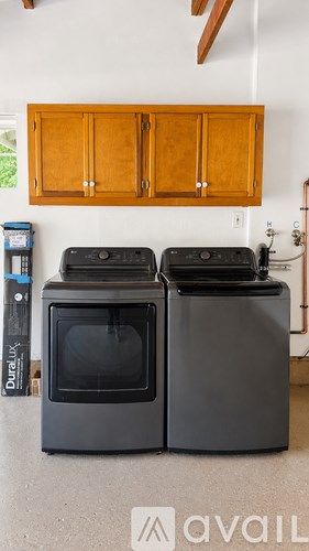 Two black ovens are in a kitchen.