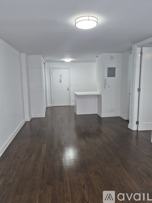 A room with wooden floors and white walls.