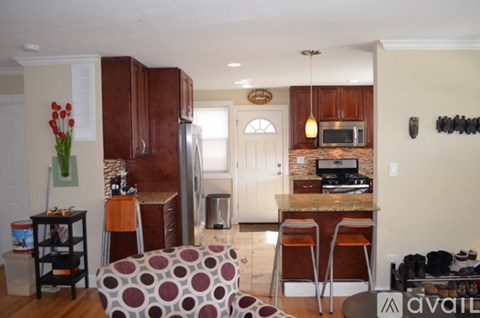 A kitchen with a refrigerator, microwave, and oven.