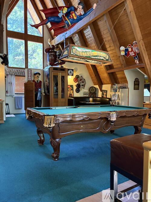 A pool table in a room with wooden beams.