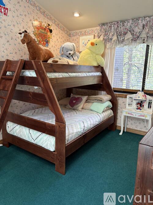 A child's bedroom with a bunk bed and stuffed animals.