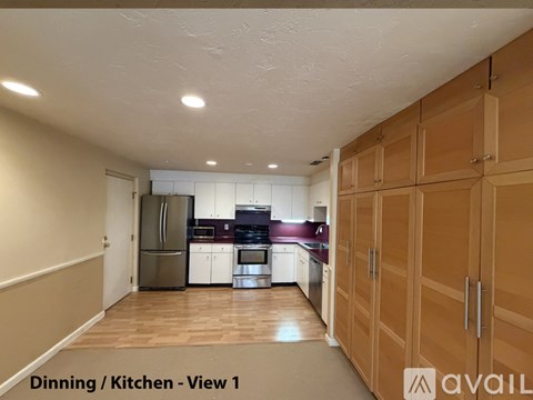 A kitchen with wooden cabinets and a refrigerator.
